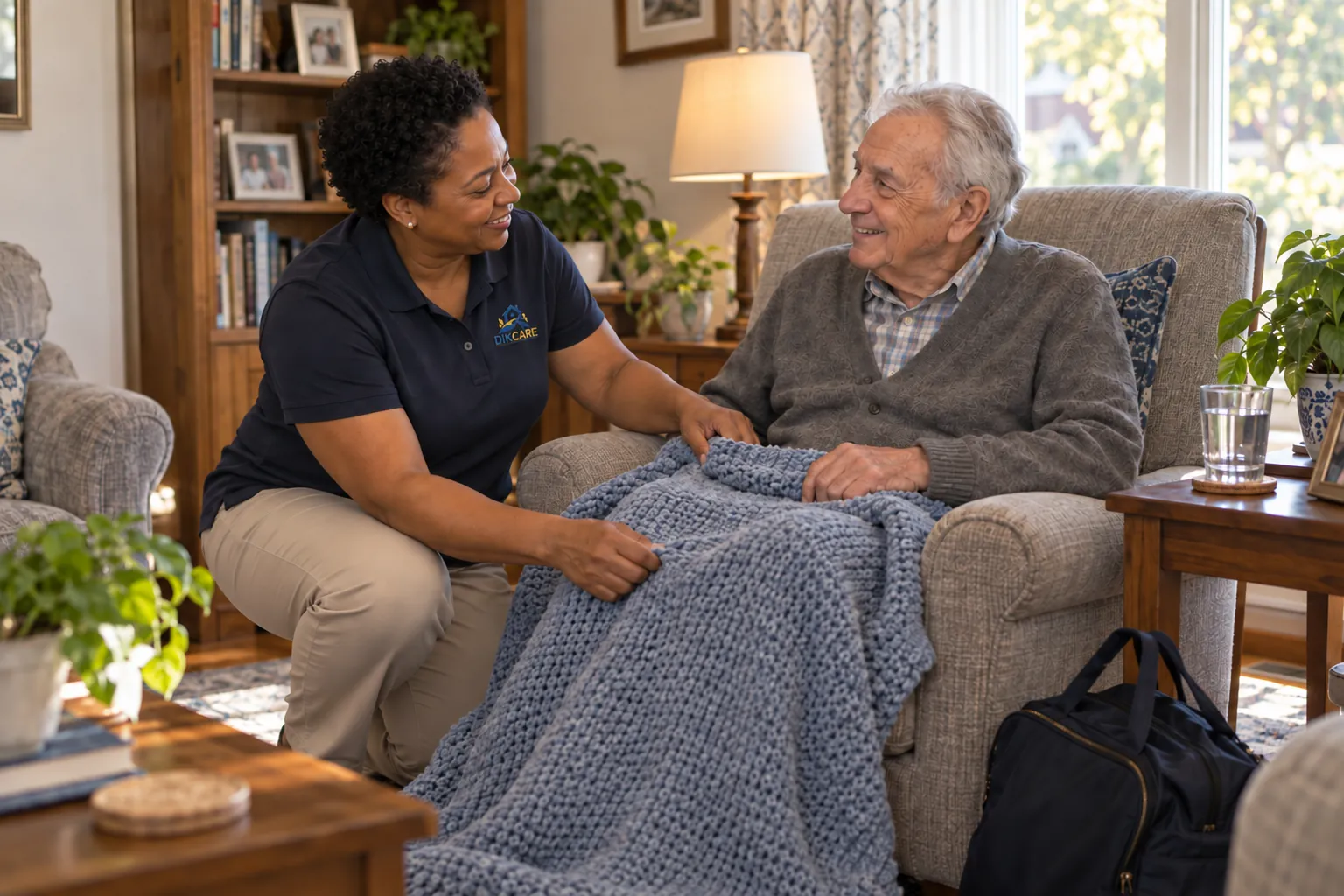 The support worker settles a senior into his armchair at home.